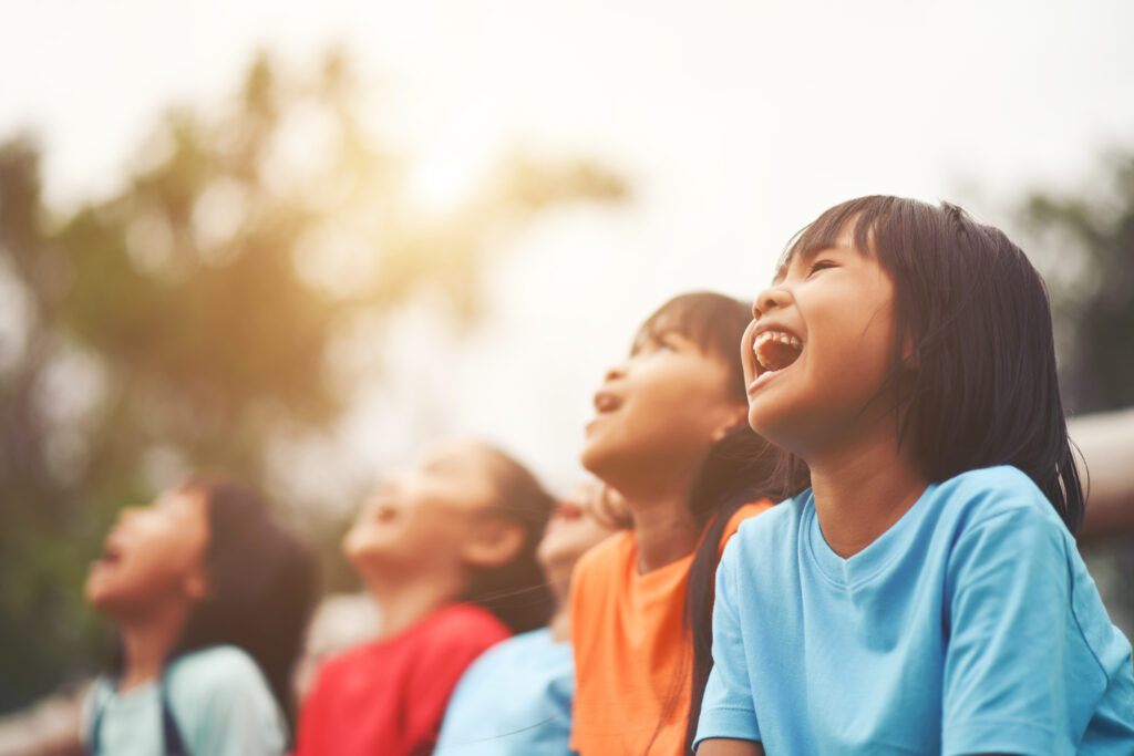 A group of kids outside singing together
